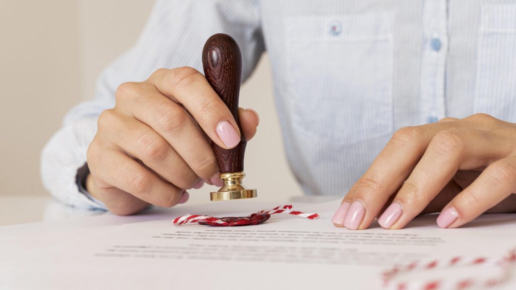 person using wax seal blurred certificate